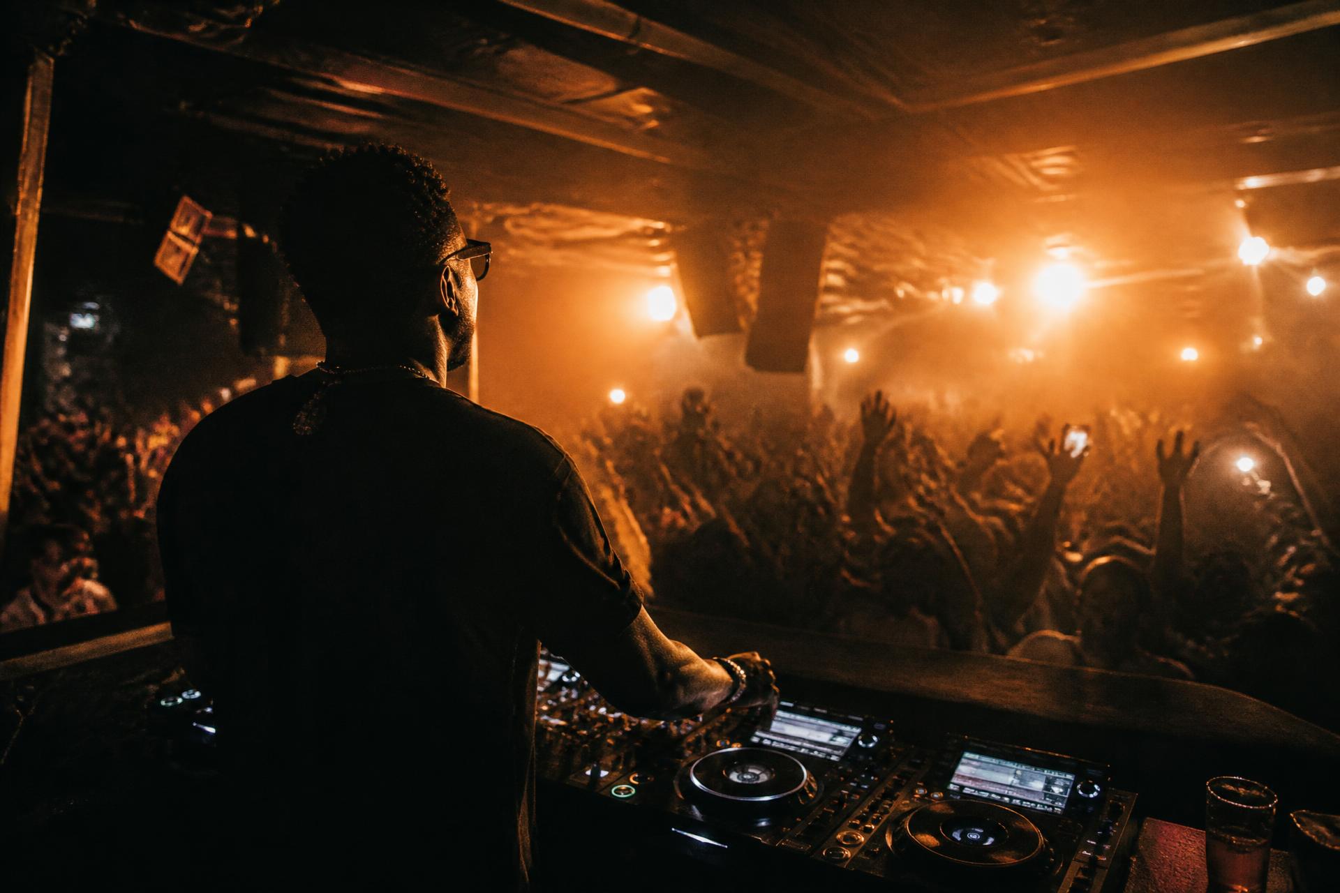DJ Bonix behind the decks in front of a packed dancefloor